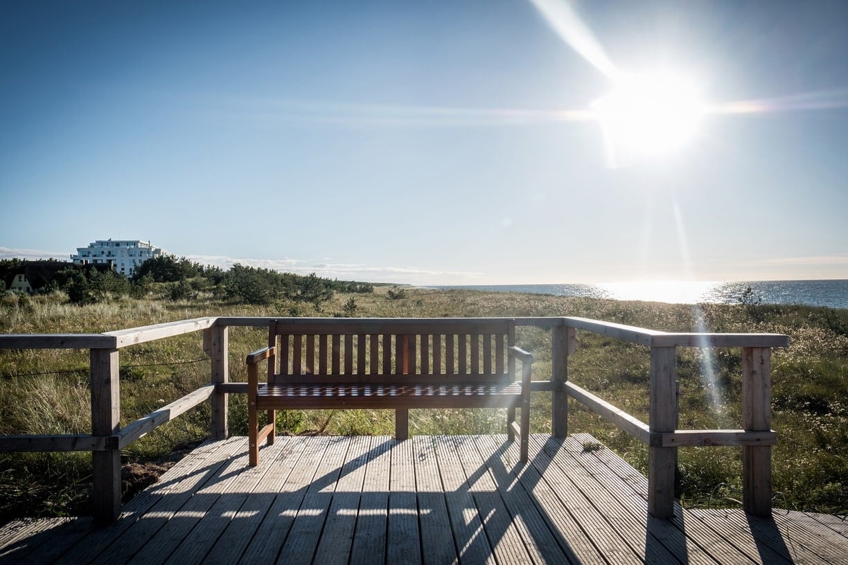 Strandhotel Dünenmeer aus der Ferne mit einer Holzbank im Vordergrund